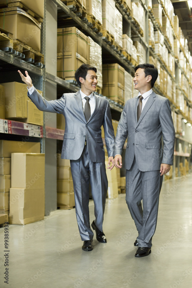 Business partners talking in logistic warehouse