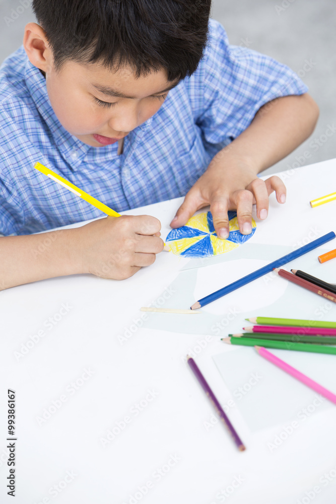 Boy making a paper toy