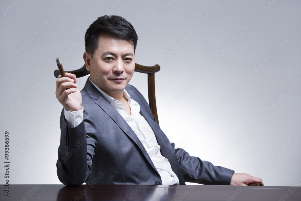 Mature businessman with cigar