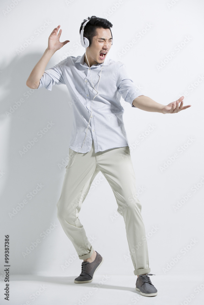 Happy young man listening to music