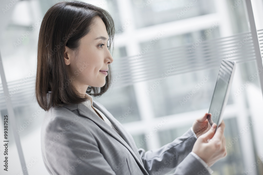 Young businesswoman using digital tablet