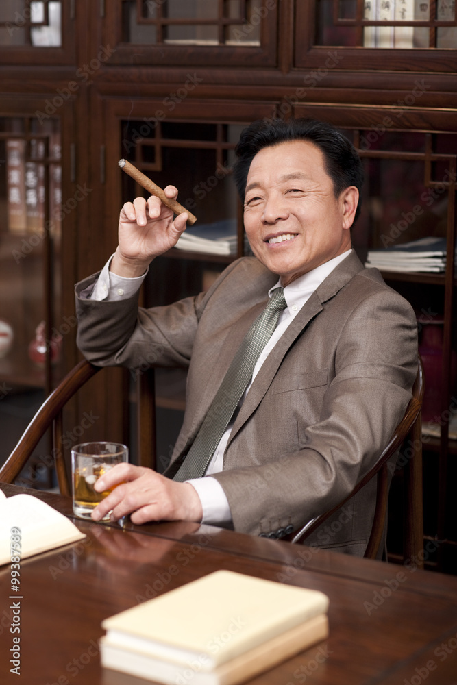 Successful businessman enjoying cigar