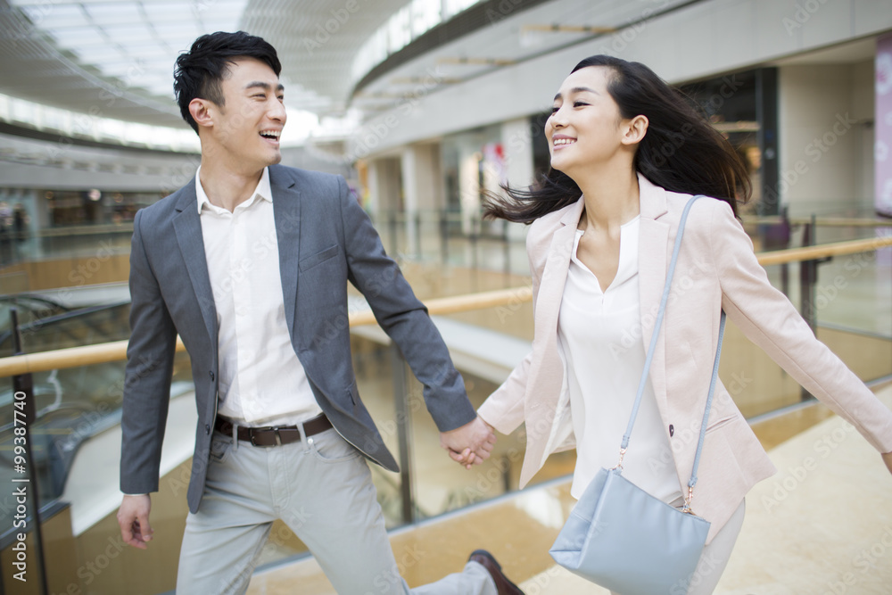 Young couple walking in shopping mall