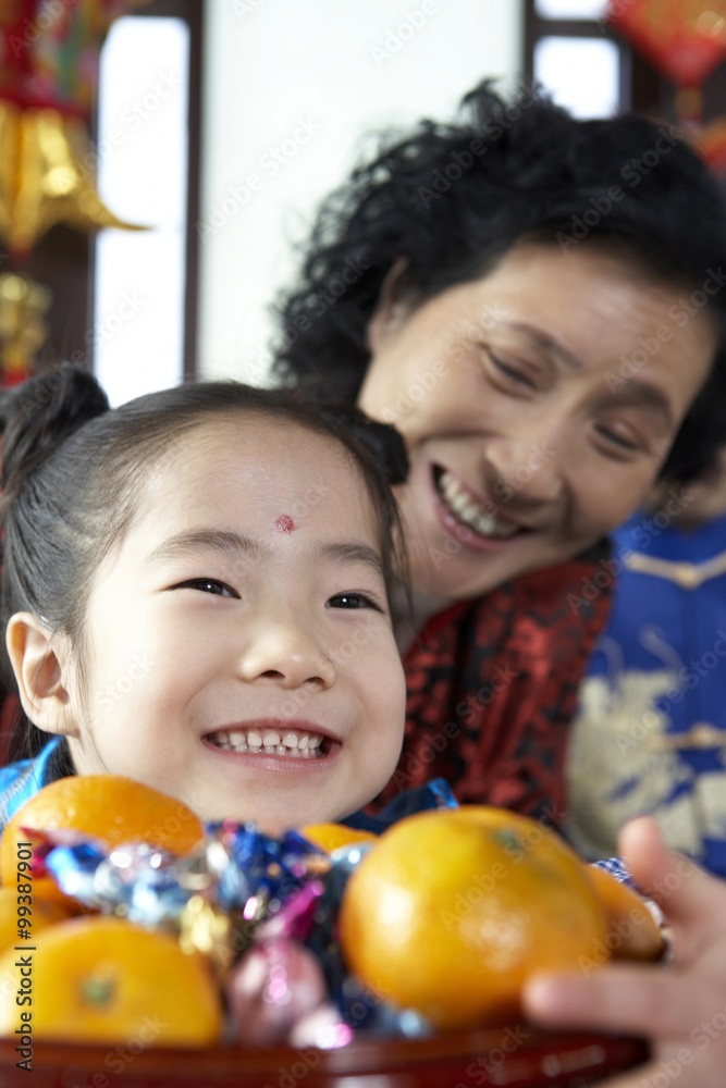 Traditionally Dressed Girl And Mature Woman Smiling