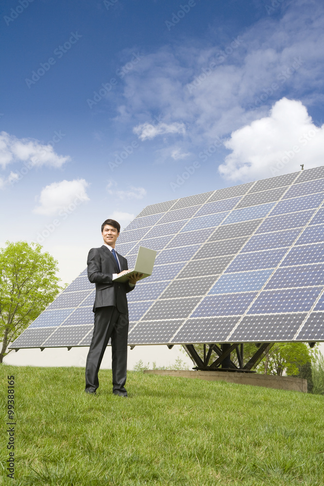 Portrait of a businessman in front of solar panels