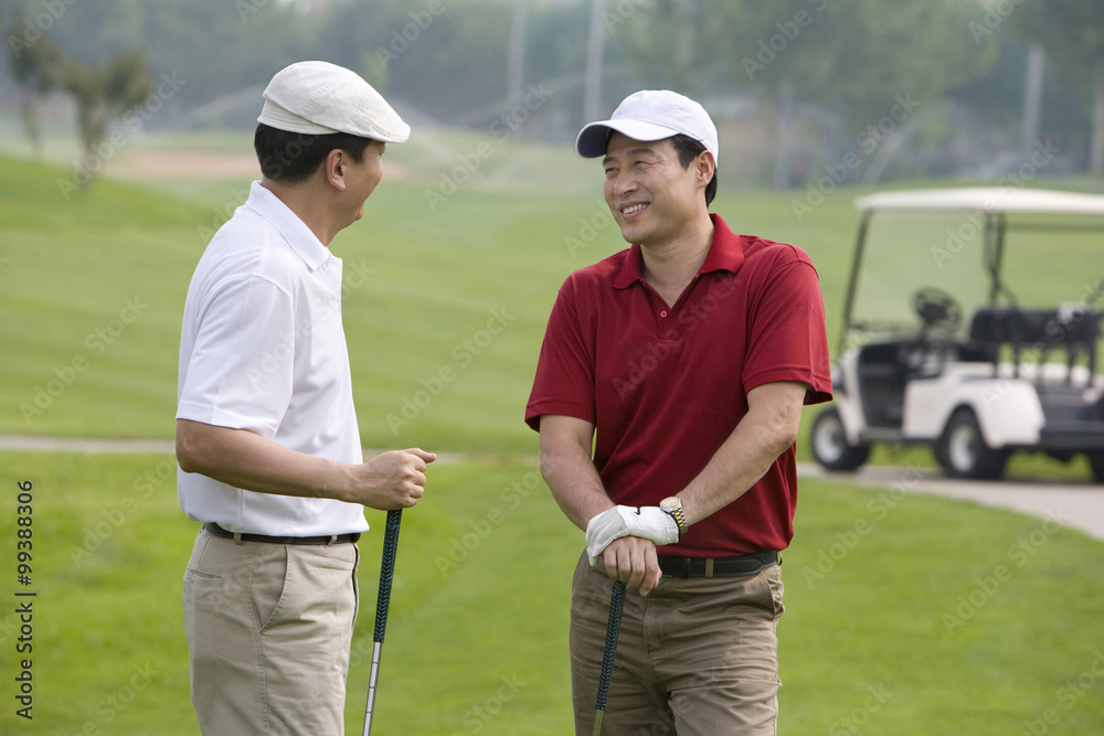 Two golfers chatting on the course