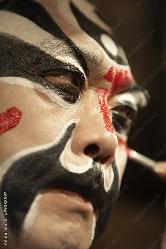 Man Applying Traditional Face Paint