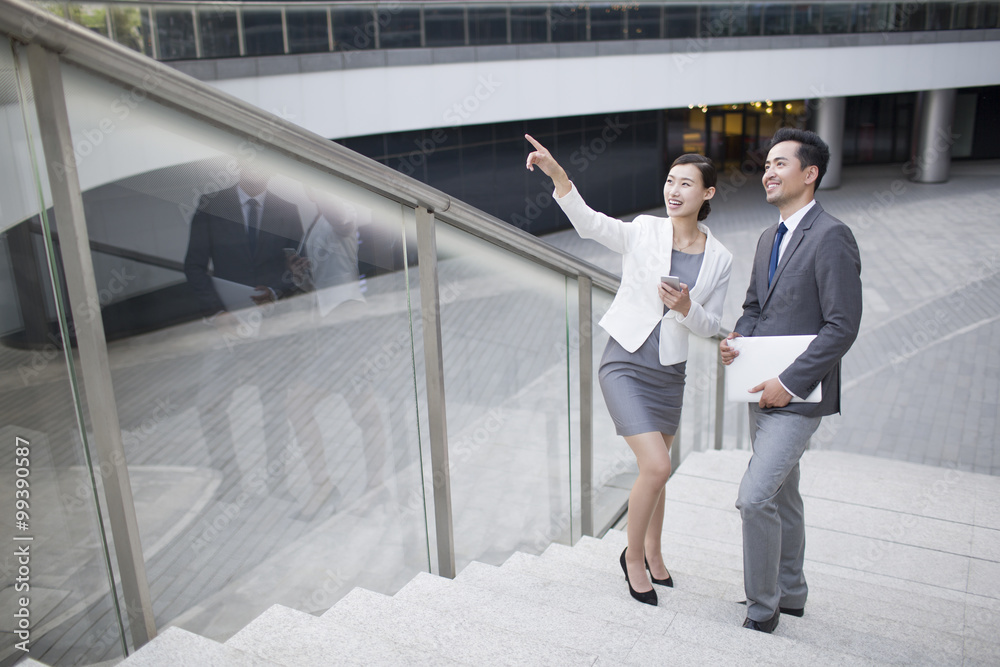 Business person pointing and looking at view