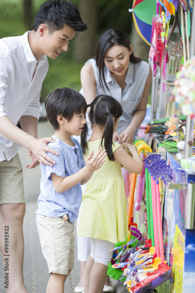 Parents and children buying toys