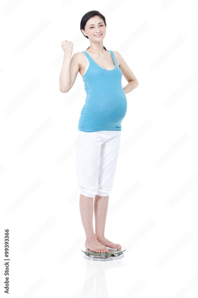 Pregnant woman measuring weight