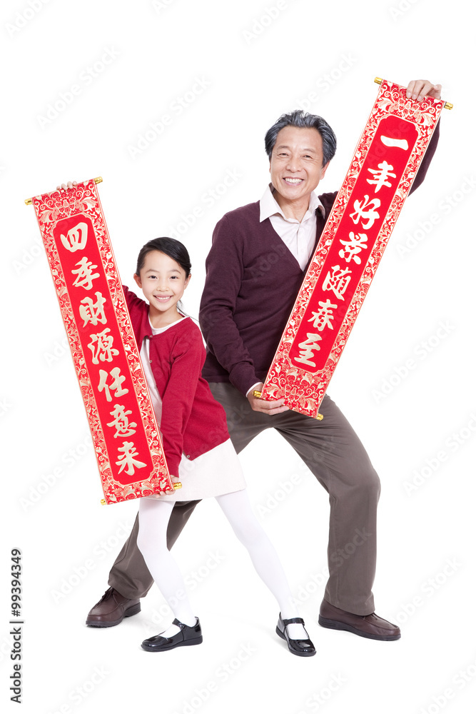 Grandfather and granddaughter holding Chinese New Year couplets