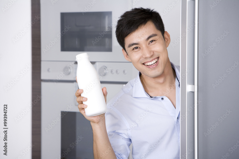 Man taking milk out of the fridge