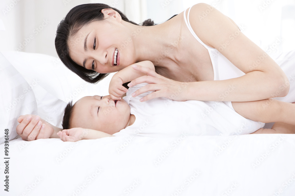 Tender mother putting baby to sleep