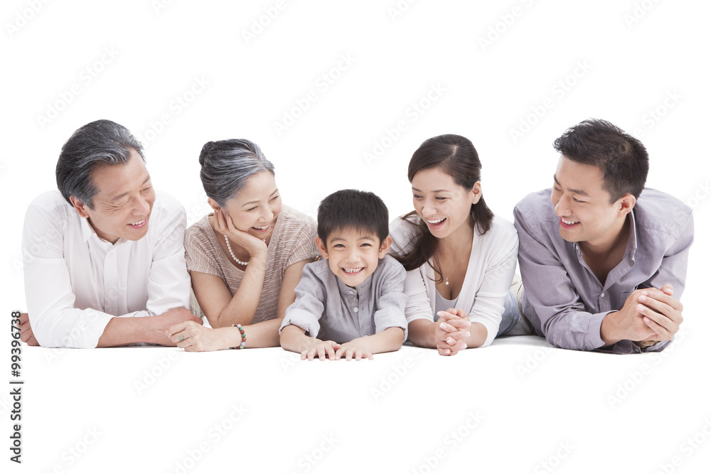 Happy three generation family lying down on ground