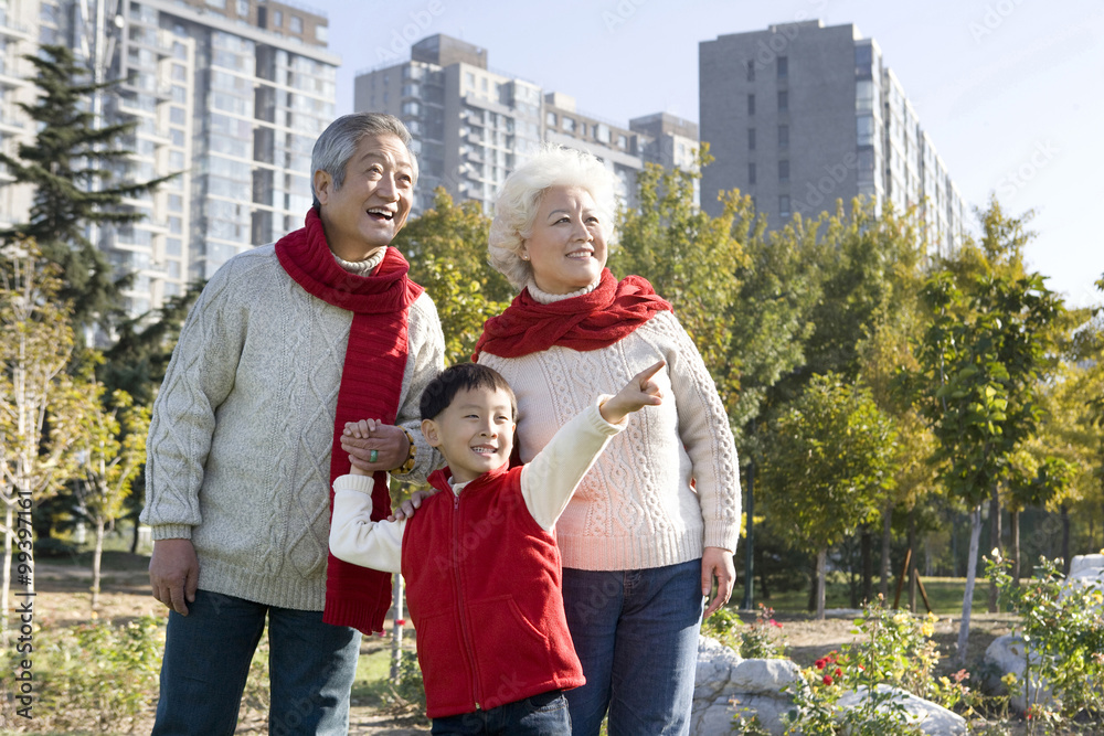 Grandparents and Grandson Enjoying a Park in Autumn