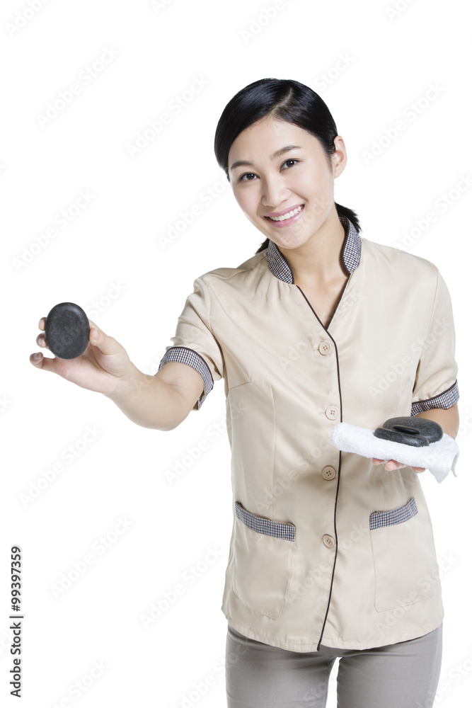 Massage therapist doing hot stone massage