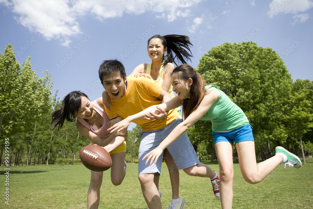 Group of friends playing American Football