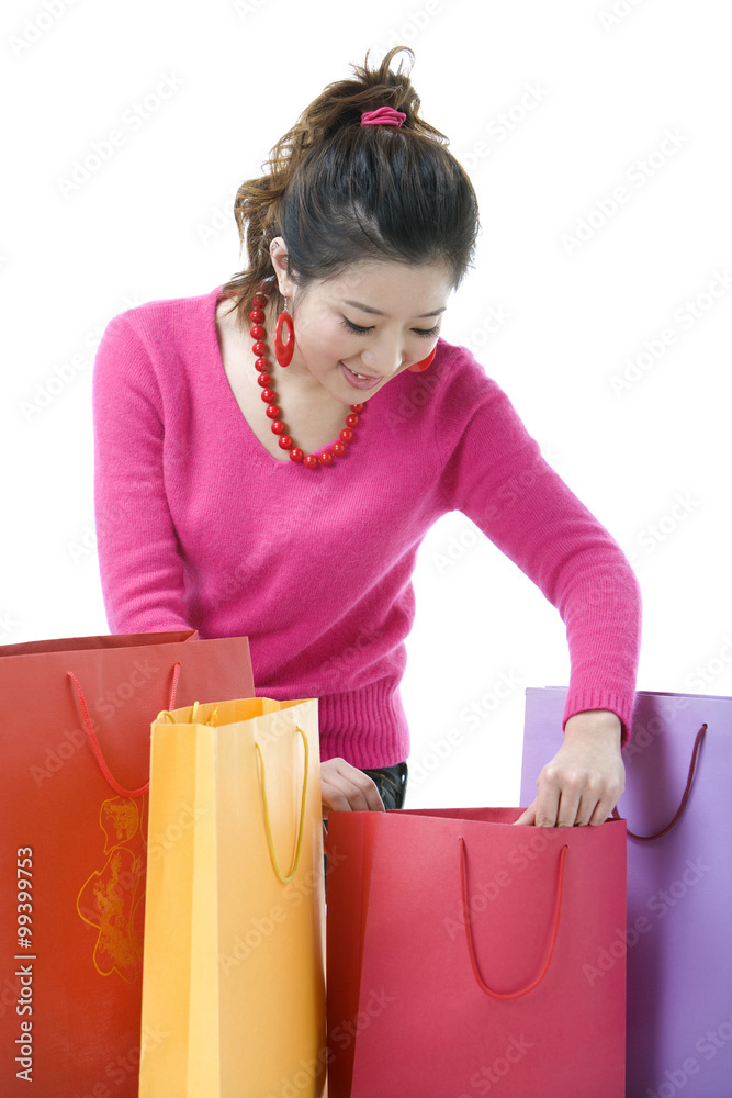 Young woman looking through shopping bags