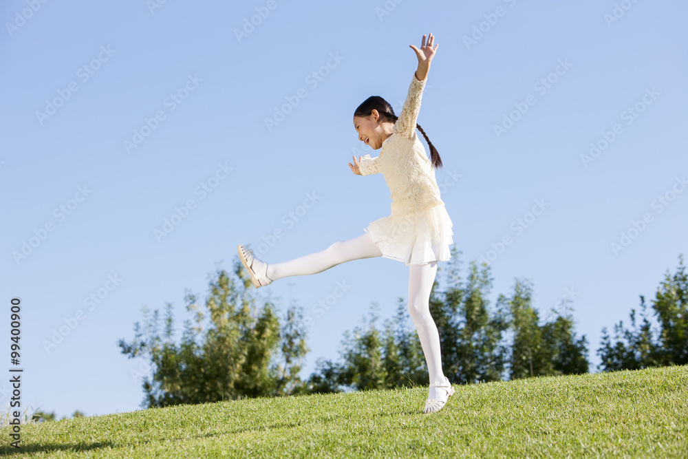 Excited young girl enjoying herself in a park