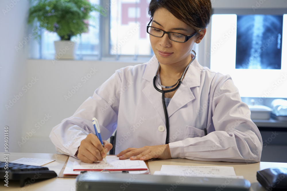 Doctor Filling In Paperwork