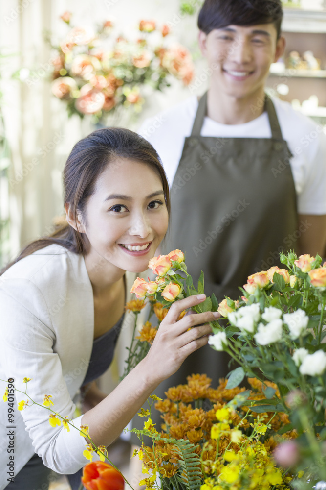 Young woman buying flowers