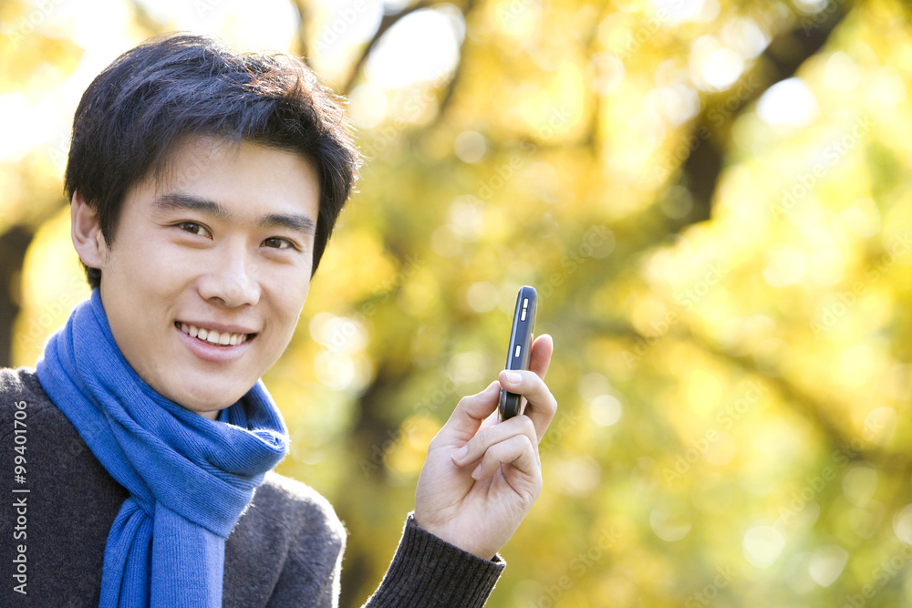 Young Man Texting on a Mobile Phone