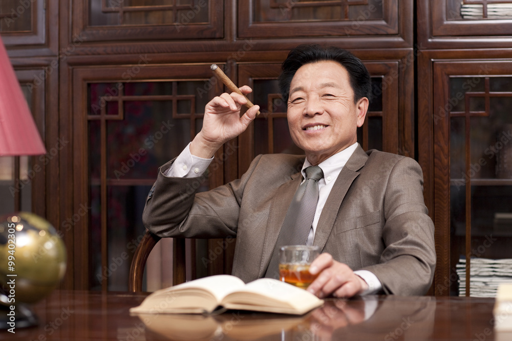 Successful businessman enjoying cigar