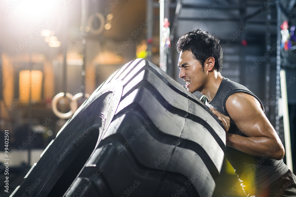 Man exercising with tractor tire