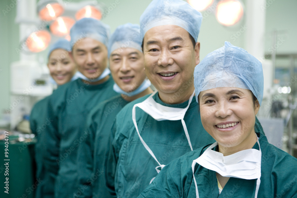 Portrait of a team of surgeons standing in a line