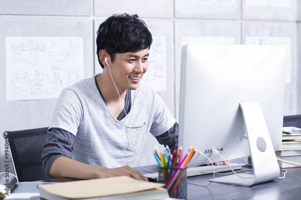 Young man surfing the net in the office