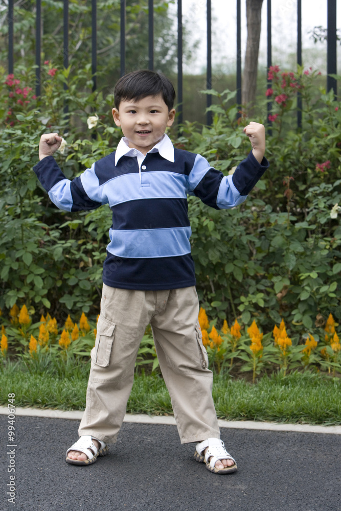 Young boy showing strength