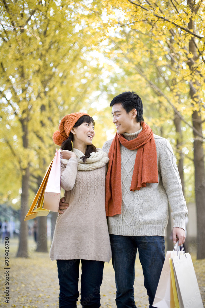 Young Couple in a Park with Shopping Bags