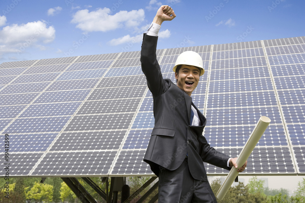 Portrait of an engineer in front of solar panels