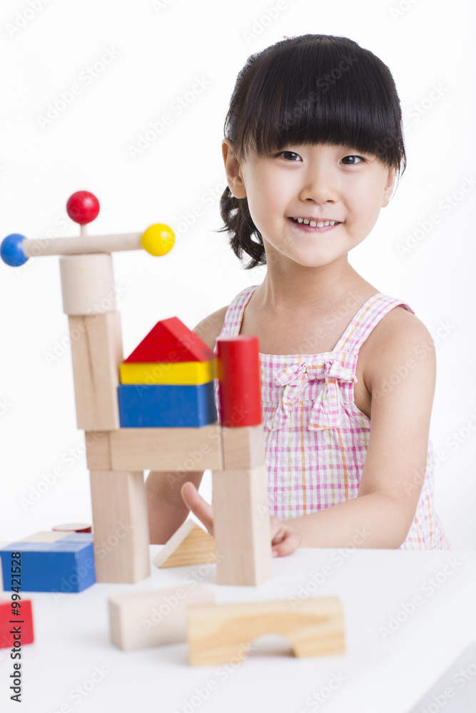 Little girl playing with building blocks