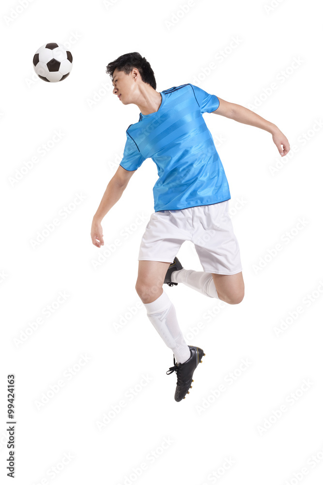 Soccer player jumping, kicking behind him