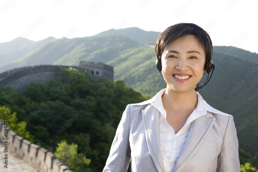 Businesswoman with headsets on the Great Wall