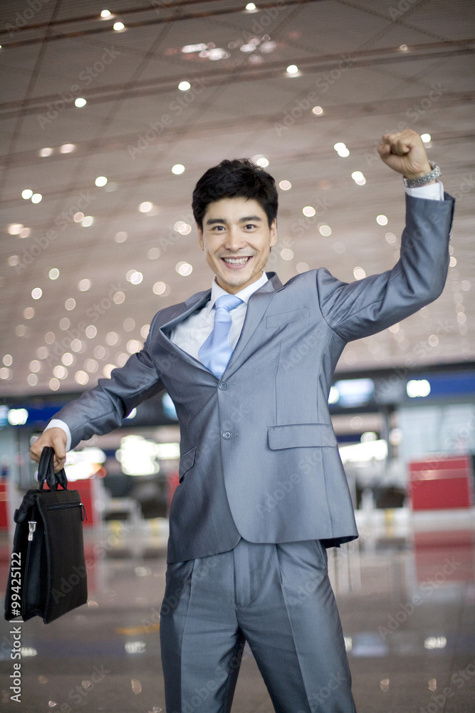 Businessman celebrating in airport