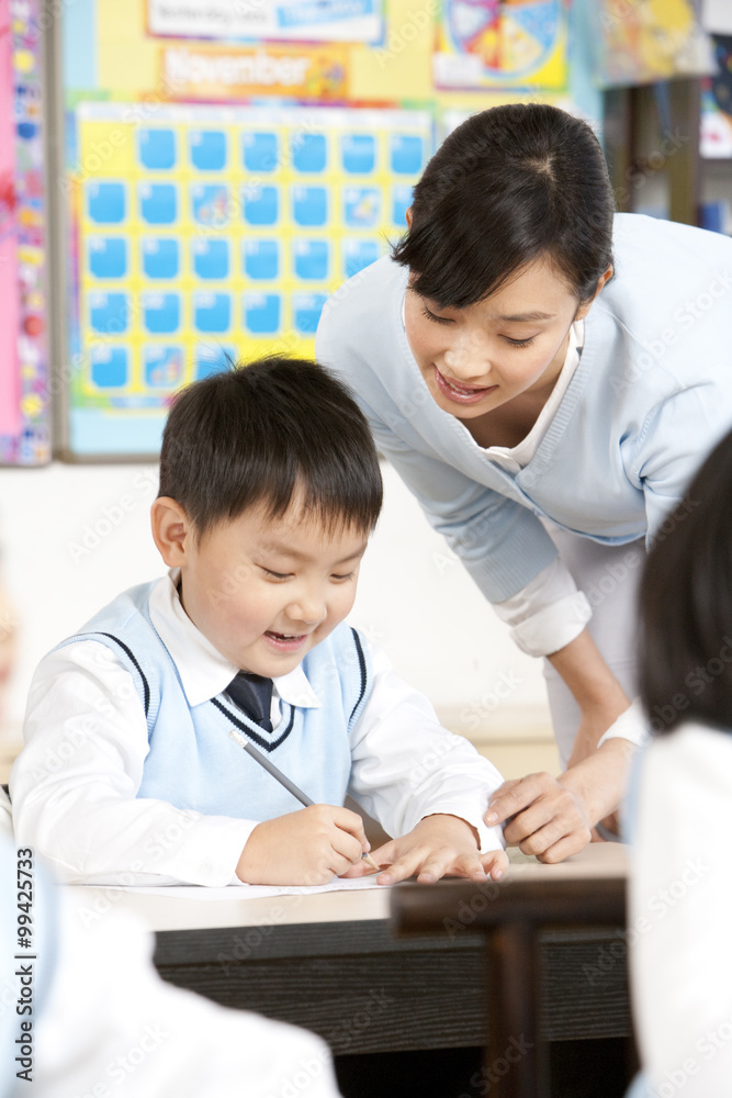 Teacher assisting student in class