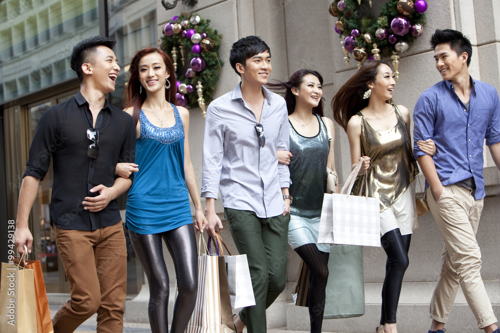 Excited young people go shopping on the street of Hong Kong