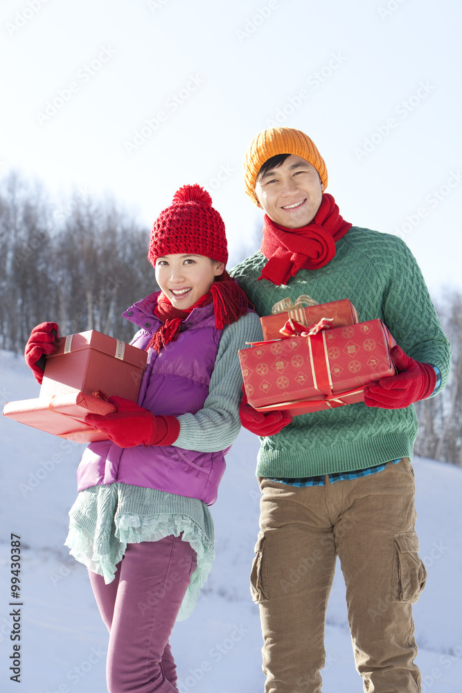 Young people holding gift boxes