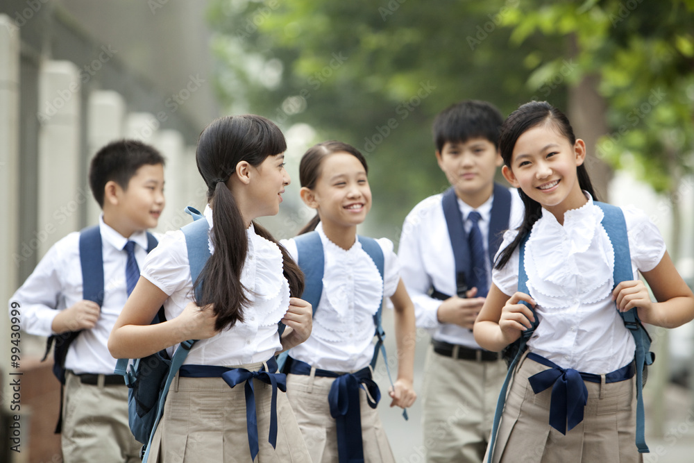 上学路上穿着校服的可爱小学生