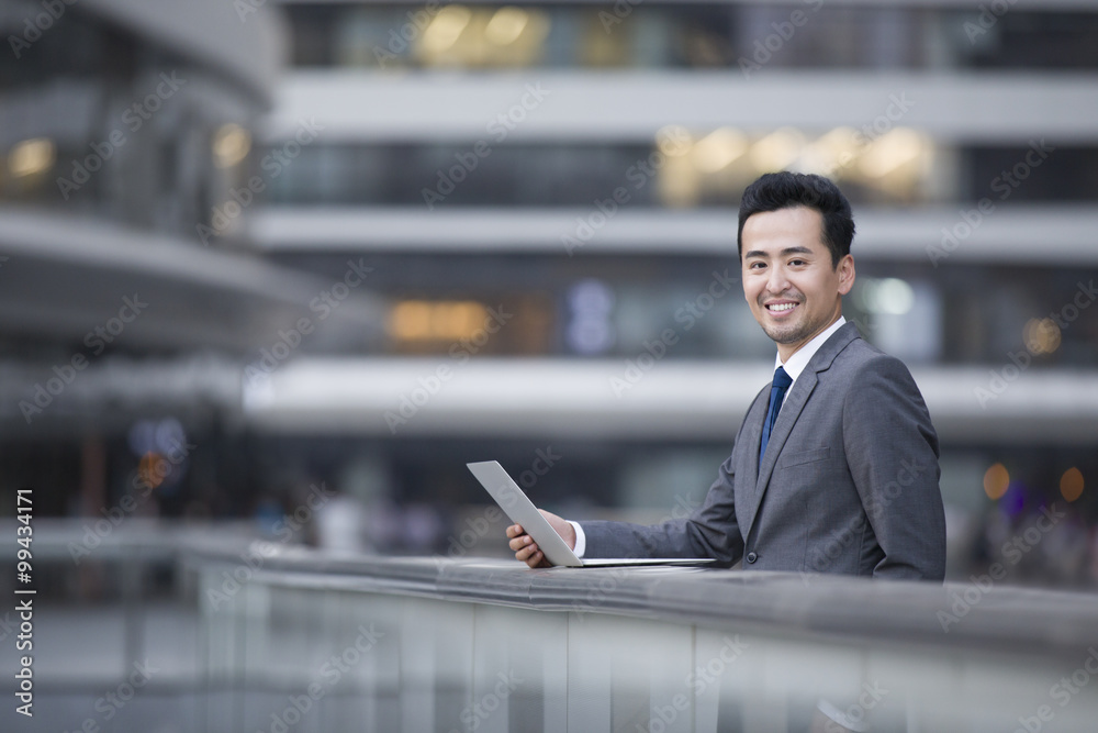 Businessman using laptop outdoors