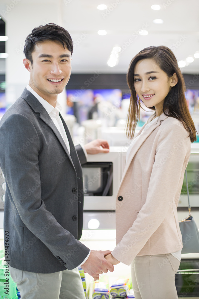 Young couple shopping in electronics store