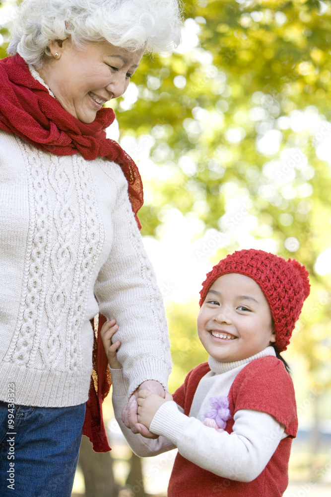 Grandmother and Granddaughter Enjoying a Park in Autumn