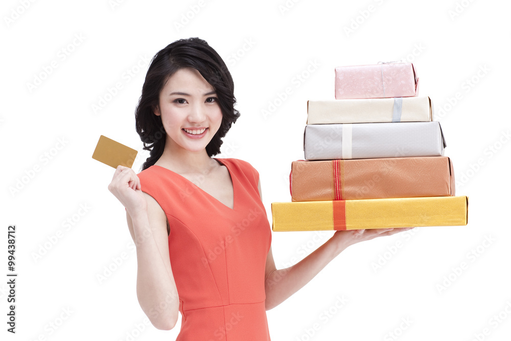 Cheerful young woman with bank card shopping