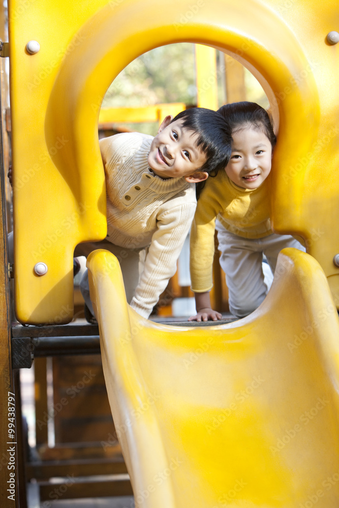 Children playing on playground slide