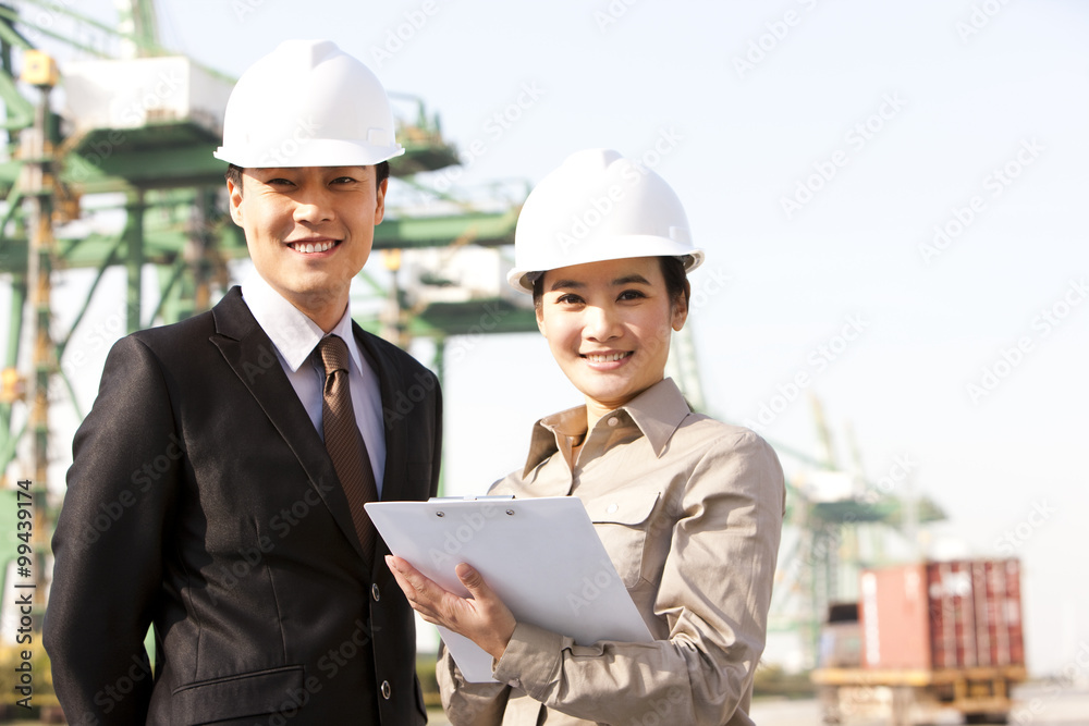 businessman with shipping industry workers in the background