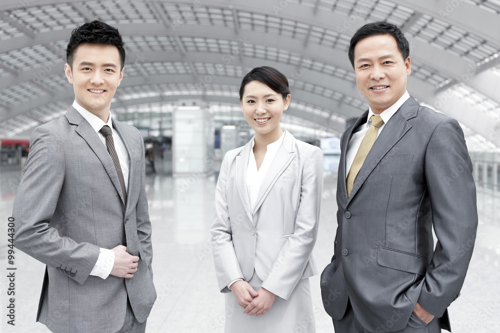 Confident business people in airport lobby