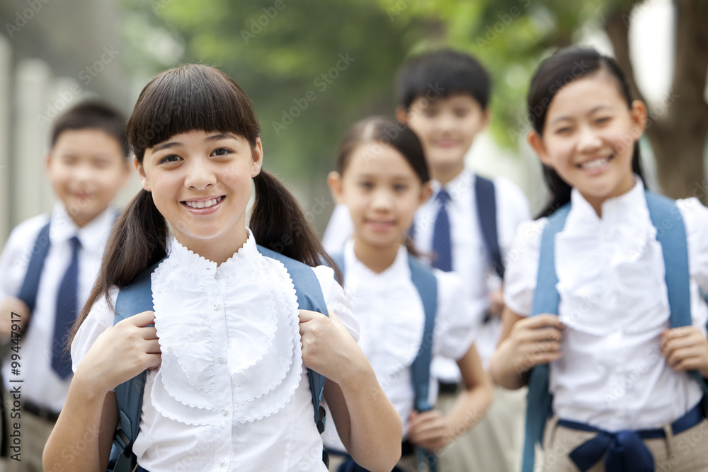 Lovely schoolchildren in uniform on the way to school