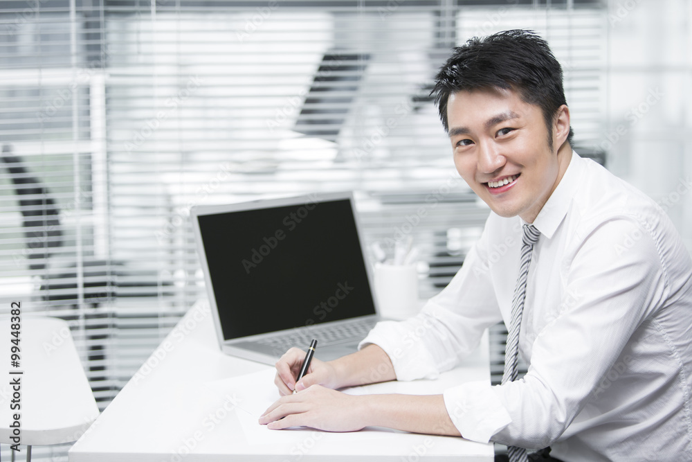 Young businessman sitting in the office